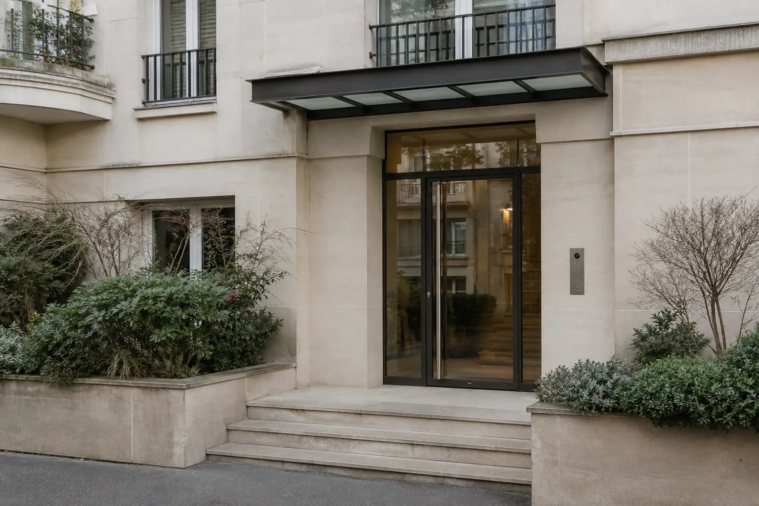 L'entrée vitrée d'un immeuble d'habitation récent.